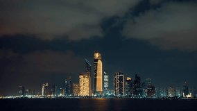 Abu Dhabi at night. Time lapse video. Moving clouds. 