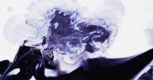 Slow motion video of purple watercolor ink mixing in water against grey background. Beautiful abstract background concept