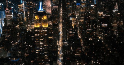 Стоковое видео: Scenic Aerial New York City View of Downtown Manhattan Architecture. High Angle Night Footage of the Business District from a Helicopter. Cityscape with Office Buildings and Busy Traffic on Streets