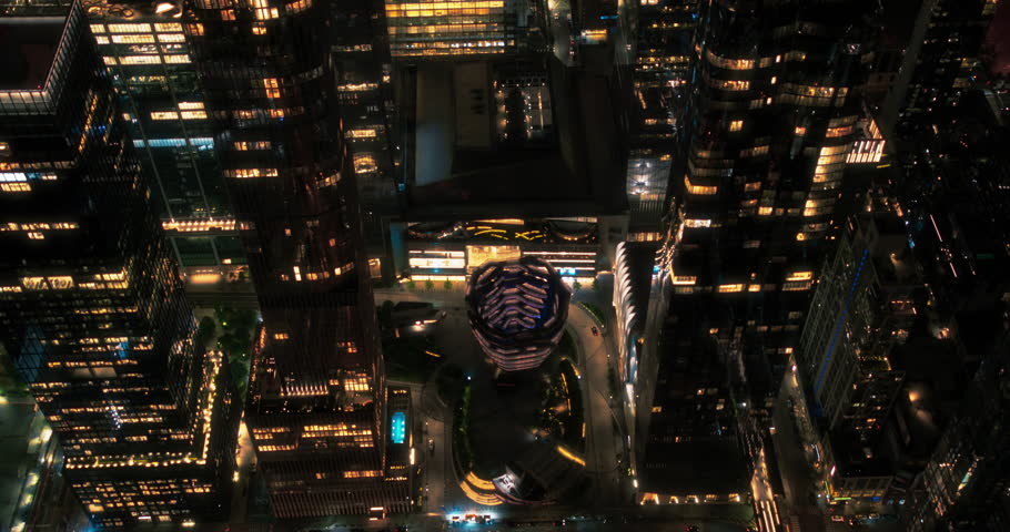 Helicopter Tour of New York City Architecture at Night. Fly-By Over Midtown Manhattan Office Buildings and Skyscrapers Towards Madison Square Garden. Aerial Urban Landscape with Lights in the Evening