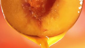 Slow Motion Macro Shot of Flowing Peach Juice from Half Peach - Powered by Shutterstock - Get 15% off with code: PIKWIZARD15