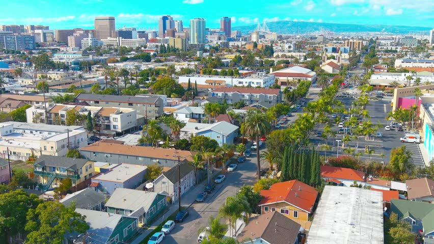 Overhead flyby of a schoolyard in Long Beach California | Afternoon lighting | View of downtown in background