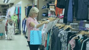 Animation of sale text over caucasian woman shopping for clothes. Sales, shopping and data processing concept digitally generated video.