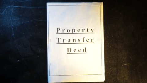 
Top view of papers of "Property Transfer Deed" lying on the ground. Hd footage of property papers on the floor. Adlı Stok Video