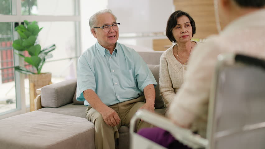 Group of asian senior people listening to young nurse.Psychological support group for elderly therapy session in a community centre. Group therapy in session sitting in a circle in a nursing home. Royalty-Free Stock Footage #1106414237