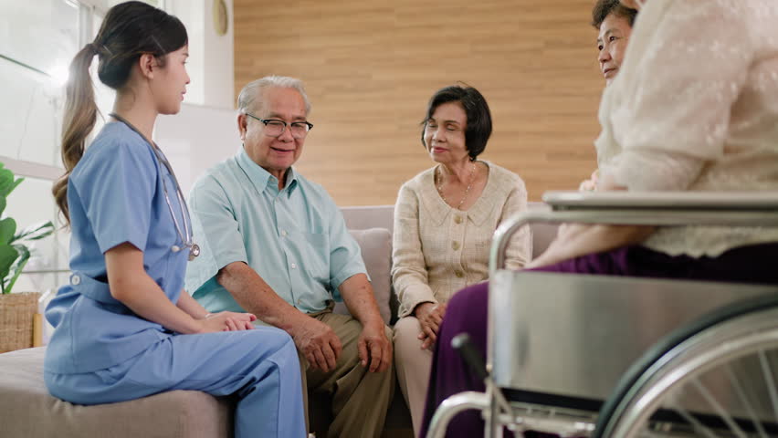 Group of asian senior people listening to young nurse.Psychological support group for elderly therapy session in a community centre. Group therapy in session sitting in a circle in a nursing home. Royalty-Free Stock Footage #1106414239