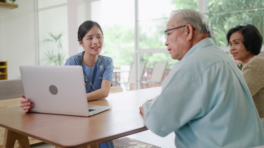 Group of asian senior people listening to young nurse.Psychological support group for elderly therapy session in a community centre. Group therapy in session sitting in a circle in a nursing home. Royalty-Free Stock Footage #1106414333