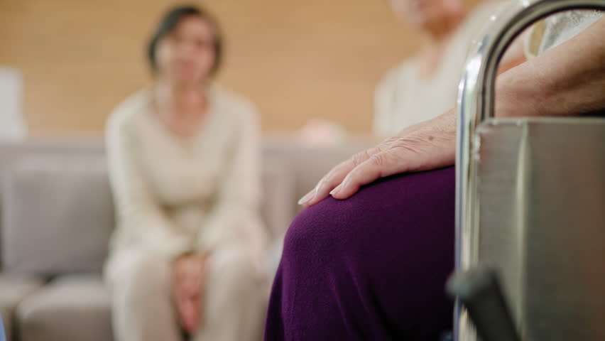 Group of asian senior people listening to young nurse.Psychological support group for elderly therapy session in a community centre. Group therapy in session sitting in a circle in a nursing home. Royalty-Free Stock Footage #1106414335