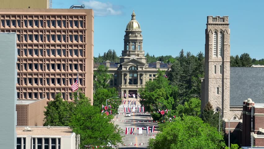 Cheyenne is the capital of Wyoming. Aerial shot of the capitol building of WY. Long zoom telephoto lens of main street with American flags in summer.