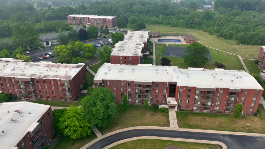 Rundown apartment complex in suburb of Chicago. Aerial orbit around dangerous, low income housing neighborhood.