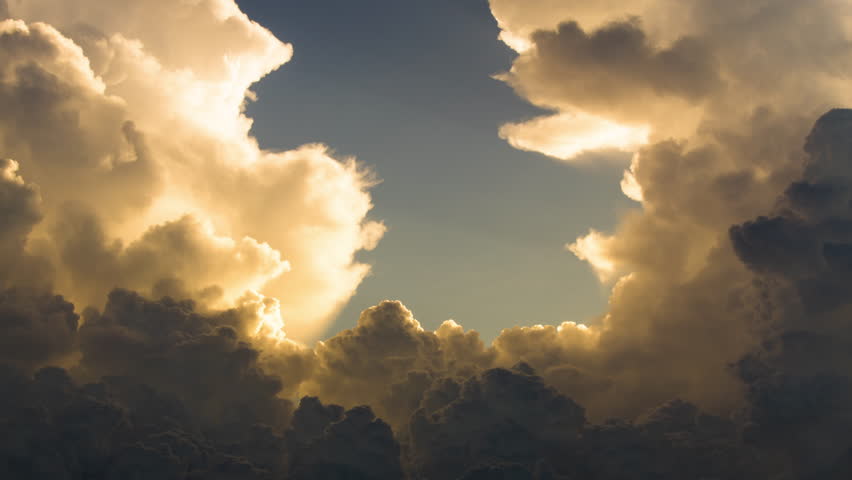 Storm clousd building, power of nature. Energetic bubbling cumulonimbus filling the scene during sunset with opening to the sky in center. Copy space.