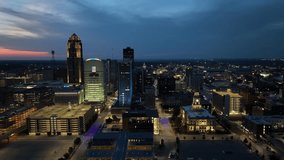 Des Moines, Iowa skyline at night with drone video moving right to left.