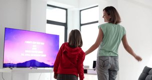 Mother and daughter dance to karaoke song on television