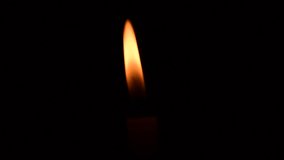 yellow candle flame lights and extinguish, isolated on a black background.central framing close up.candle is blown out in dramatic slow motion,  - Powered by Shutterstock - Get 15% off with code: PIKWIZARD15