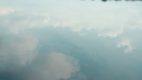 A blue heaven with white clouds reflecting in lake water. Natural background with copy space with river surface and blue cloudy sky in tropics. Peaceful scene outdoors. Ripple on pond in summer - Powered by Shutterstock - Get 15% off with code: PIKWIZARD15