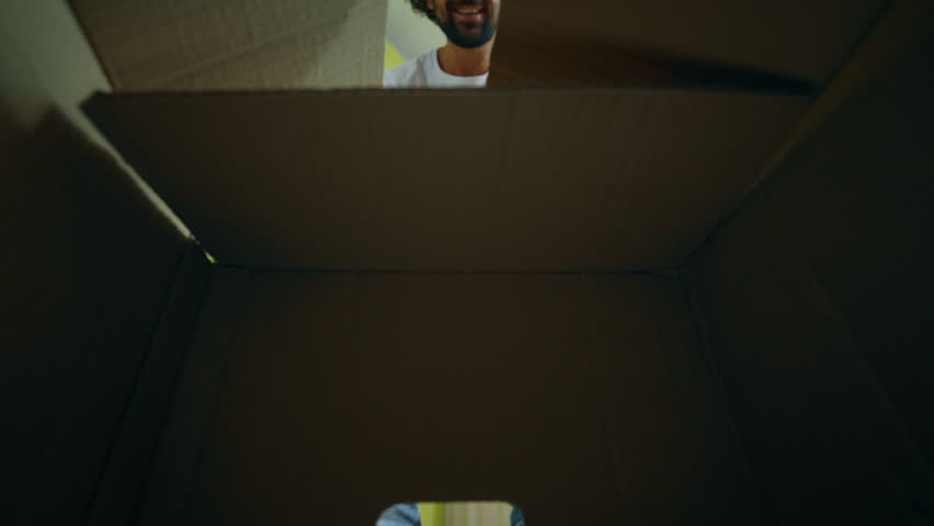 Taking video closeup happy man open the box in the living room and take a small watch and arrange the watch on the living shelves | Shutterstock HD Video #1106419737