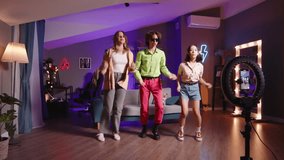 Group of friends recording dance video. Multi-ethnic bloggers record video stories or reels. Dance performance of multi-ethnic group of friends became viral hit. Friends record dance stories or reels
