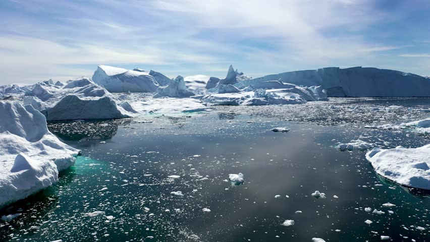 Arctic landscape. Icebergs melt at turquoise ocean bay. Huge ice glacier at polar nature environment. Arctic winter landscape at global warming problem. Desert white land of snow and ice drone shot. Royalty-Free Stock Footage #1106422201