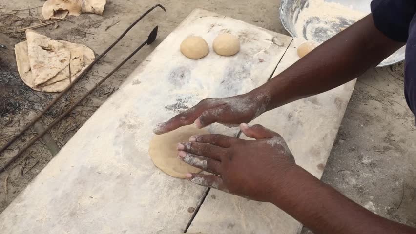 An Pakistani man in outdoor Kitchen preparing to make Pakistani bread Roti or Chapati in the traditional Pakistani way Royalty-Free Stock Footage #1106426529