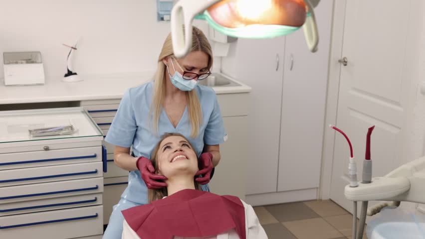 Orthodontic specialist, Female diagnosis, Jaw diagnosis. Doctor, who is specialist in gnathology and orthodontics, is checking jaw joints female patient. Royalty-Free Stock Footage #1106428907