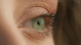 Side view of young woman with incredible light green eyes. Close up shot of eye opening with beautiful teal iris. Healthy eyesight concept 4K RED camera footage. Macro close up shot female human eye - Powered by Shutterstock - Get 15% off with code: PIKWIZARD15