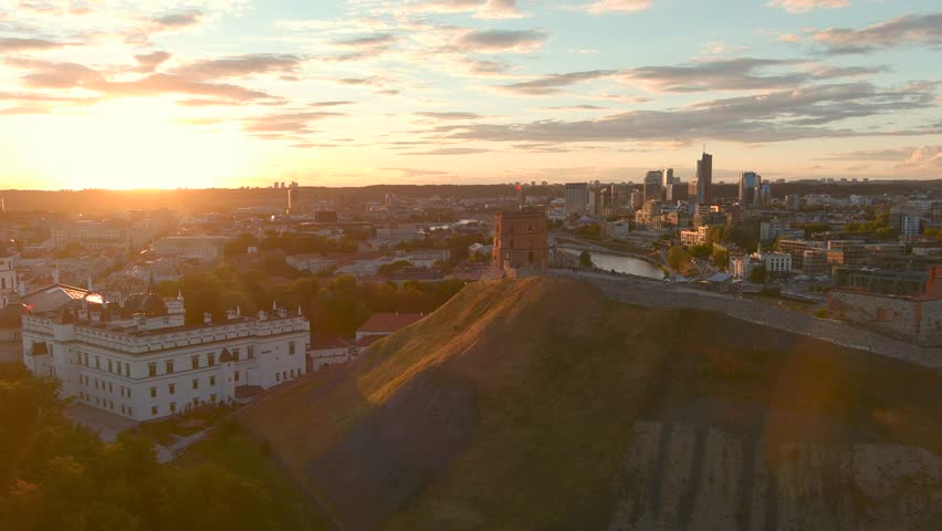 Sunset aerial view of Gediminas Tower, the remaining part of the Upper Castle in Vilnius. Sunset landscape of UNESCO-inscribed Old Town of Vilnius, the heartland of the city, Lithuania. Royalty-Free Stock Footage #1106432439