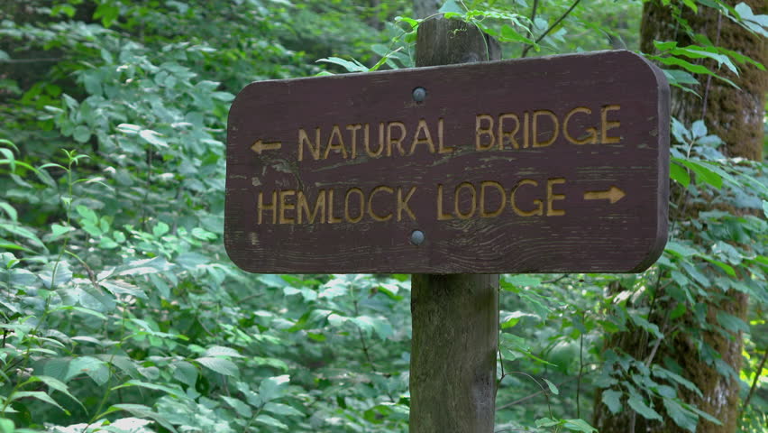 Natural Bridge and Hemlock Lodge sign in woods