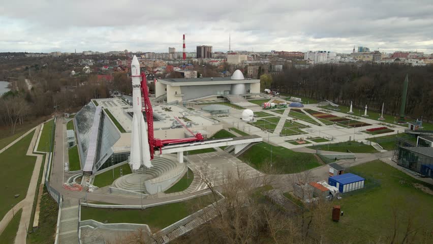 POV an aerial view of an outdoor exhibit. The museum displays models of Sputnik-1 type spacecraft and samples of lunar dust, a rocket park, in particular, the R-7