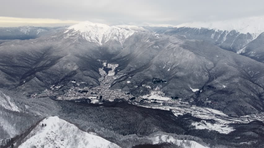 City Between Mountains In Winter