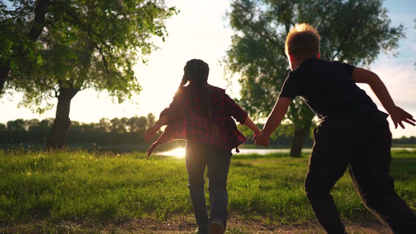 children run holding hands. happy family. silhouette group of children at sunset run through the park in nature. happy family kid lifestyle dream concept. happy kids running together silhouette Royalty-Free Stock Footage #1106448001