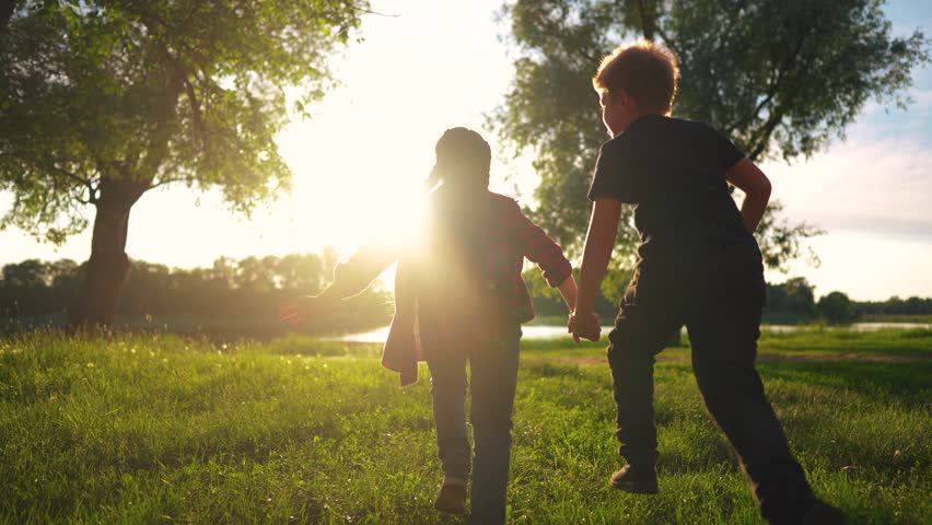 children run holding hands. happy family. silhouette group of children at sunset run through the park in nature. happy family kid lifestyle dream concept. happy kids running together silhouette Royalty-Free Stock Footage #1106448001