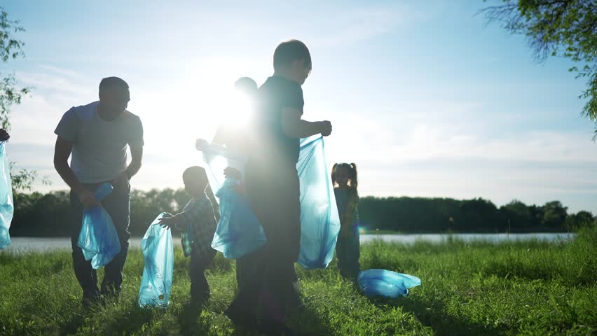 group of volunteers clean up trash. environmental protection ecology cleaning from garbage plastic concept. group people volunteers collects plastic bottles garbage in bags silhouette world Royalty-Free Stock Footage #1106448015