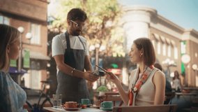Female is Making a Payment to a Waiter with Her Smartphone. Friends are Enjoying Cake Desserts on a Terrace in a Cafe and Closing the Bill with a Contactless NFC Function on a Mobile Device - Powered by Shutterstock - Get 15% off with code: PIKWIZARD15