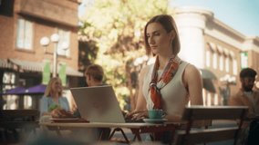 Female Freelancer Using Laptop Computer for Remote Online Work in a Cafe. Young Creative Woman Having Breakfast Croissant with Coffee while Teleworking From a Terrace on a Sunny Summer Day - Powered by Shutterstock - Get 15% off with code: PIKWIZARD15