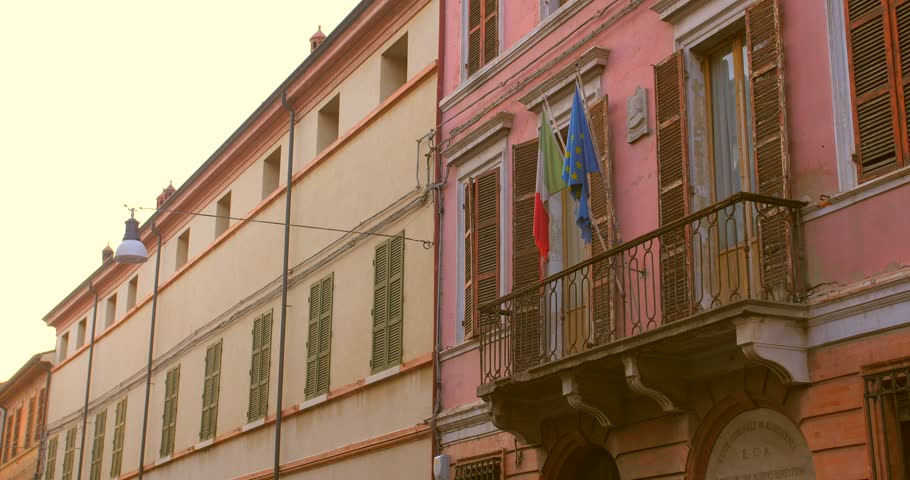 Flags Of Italy And European Union On Building Facade In Old Town Of Forli, Emilia-Romagna, Italy. lateral view