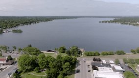 Lake Cadillac in Cadillac, Michigan with drone video moving in wide shot.