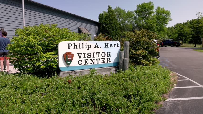 Phillip A. Hart Visitor Center sign at the Sleeping Bear Dunes National Lakeshore in Empire, Michigan with gimbal video moving in slow motion.