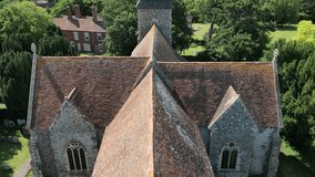 A slow upward boom-shot showing the top of St John the Evangelist church in Ickham, Kent.