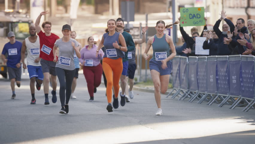 Women Supporting Women: Portrait of Happy Female Runners Participating in a Marathon. Group of Friends Celebrating Together and Congratulating Each Other on Crossing the Finish Line Royalty-Free Stock Footage #1106455909