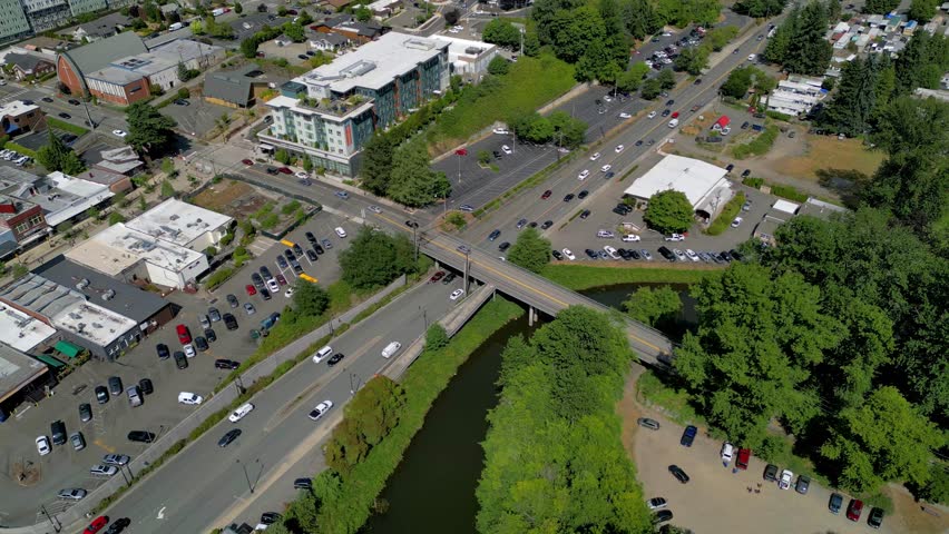 Aerial view of down town Bothell Washington USA with many cars roads bridges greenery buildings architecture view. Small city family friendly pacific northwest place to live vacation holiday location