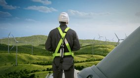 Caucasian Male Sustainable Energy Engineer Using Laptop On Top Of Industrial Wind Turbine. Professional Man Wearing Safety Equipment and Working On Wind Farm, Source Of Clean Energy. Zoom Out Backview - Powered by Shutterstock - Get 15% off with code: PIKWIZARD15