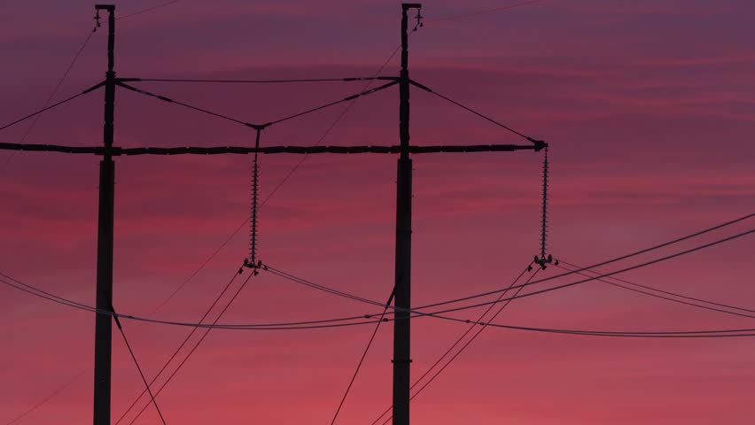Silhouette of large overhead power lines during sunrise in Estonia, Northern Europe Royalty-Free Stock Footage #1106458623