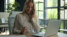 Happy Caucasian businesswoman talk phone conversation consult client business commerce in office smiling woman girl multitask working use laptop check documents on desk support customer mobile call - Powered by Shutterstock - Get 15% off with code: PIKWIZARD15