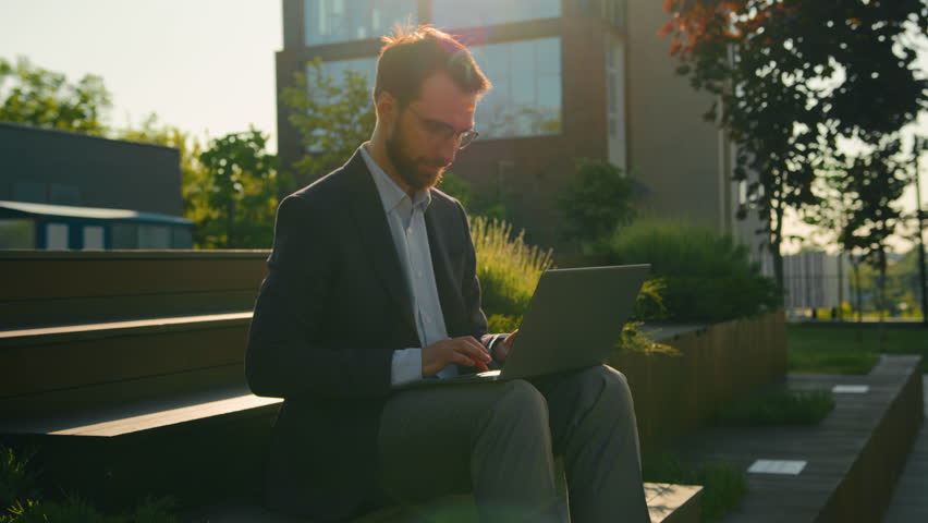 Successful businessman working on steps near office or university use laptop Caucasian business man check email on computer distant work outdoors happy employer in city smiling at camera toothy smile Royalty-Free Stock Footage #1106463829