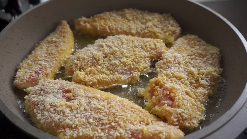homemade schnitzel, chicken pieces fried in oil