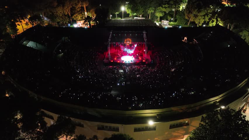 aerial view with drone of people watching concert and having fun in open air theater