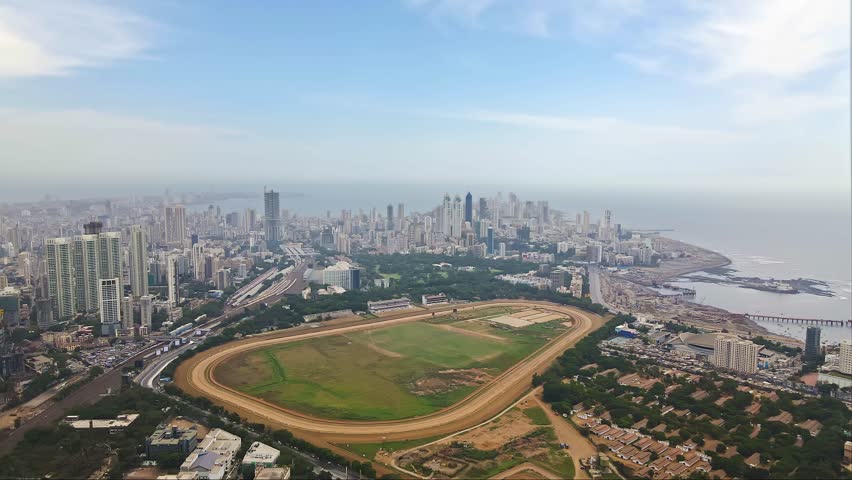 Aerial footage of Mumbai city scape over south Mumbai with Mahalaxmi Racecourse in view. Greater Mumbai drone footage. Drone shot of downtown Mumbai with a seaface view Royalty-Free Stock Footage #1106478903