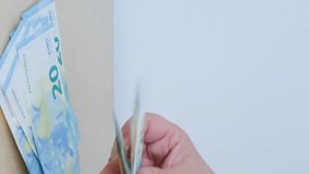 female hands count paper 10, 20 euro banknotes, puts on table, concept of human poverty, devaluation, inflation, payments to fund, gift for holiday, social assistance poor, 4K vertical video - Powered by Shutterstock - Get 15% off with code: PIKWIZARD15