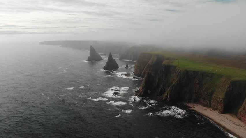 Aerial shot of the coast line of Duncansby Head in the Scottish Highlands. Drone shot of dramatic sea stacks at Duncansby Head near John O
