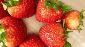 Macro video showcasing the exquisite details of strawberries using a probe lens. Witness the vibrant red hues, intricate seeds, and luscious texture in close-up shots. Strawberry background. 4K HDR
